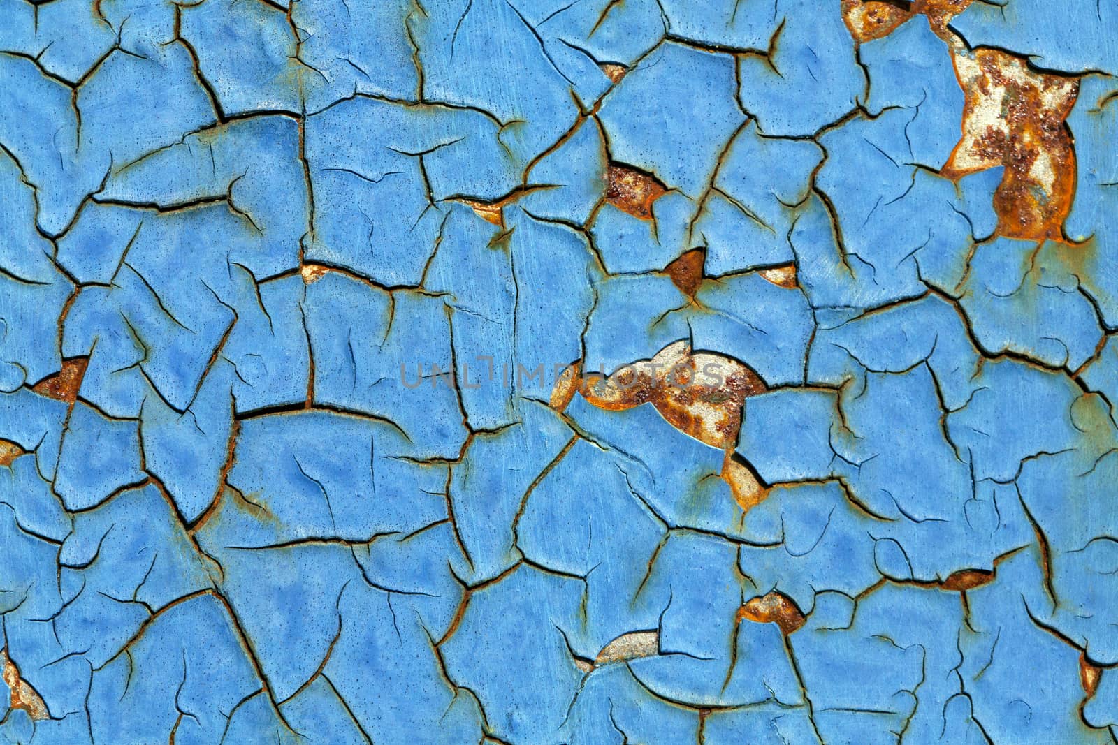 Close-up of peeling paint and rust on a wall