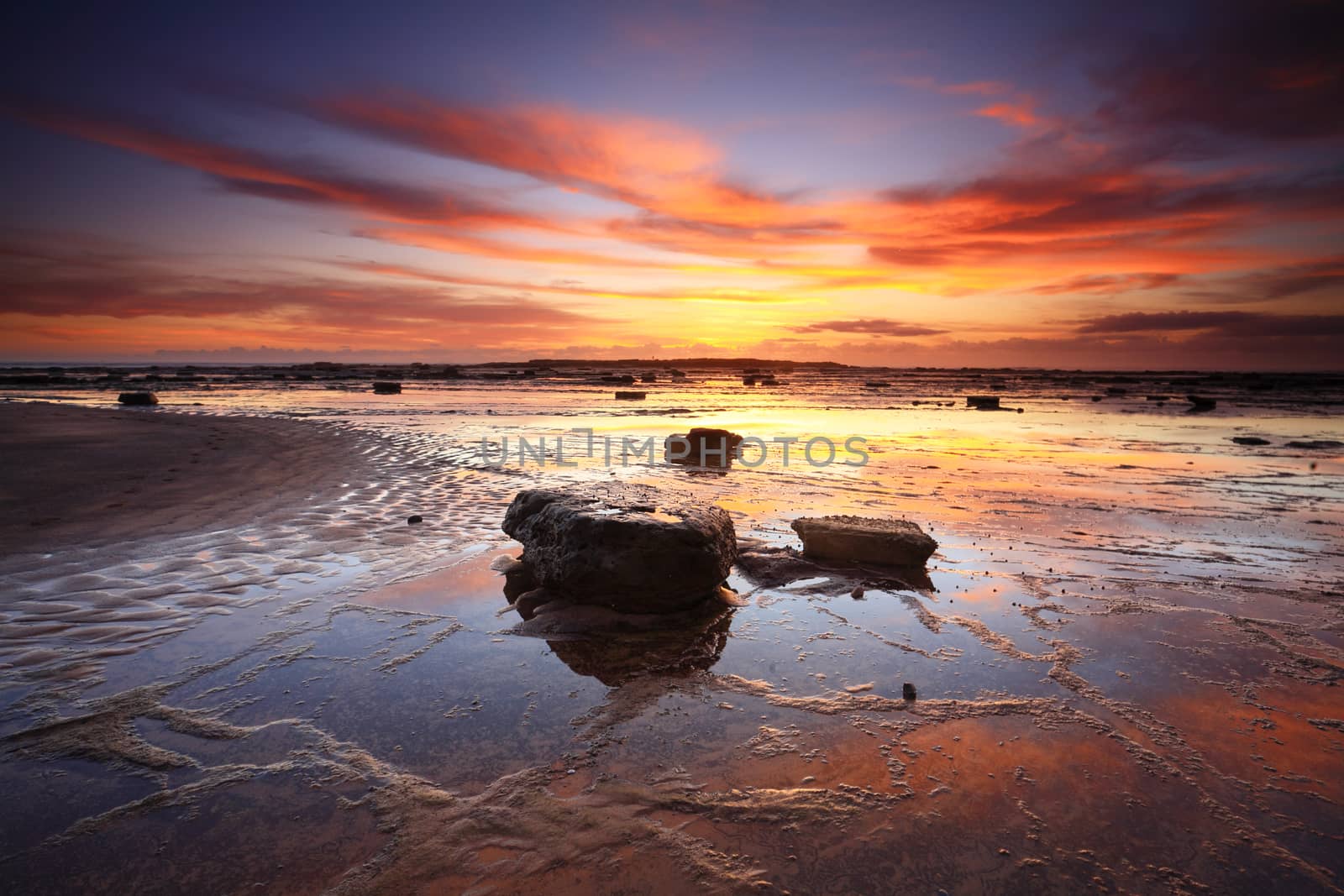 Vivid sunrise and reflections across Long Reef in Sydney's Northern beaches, Australia