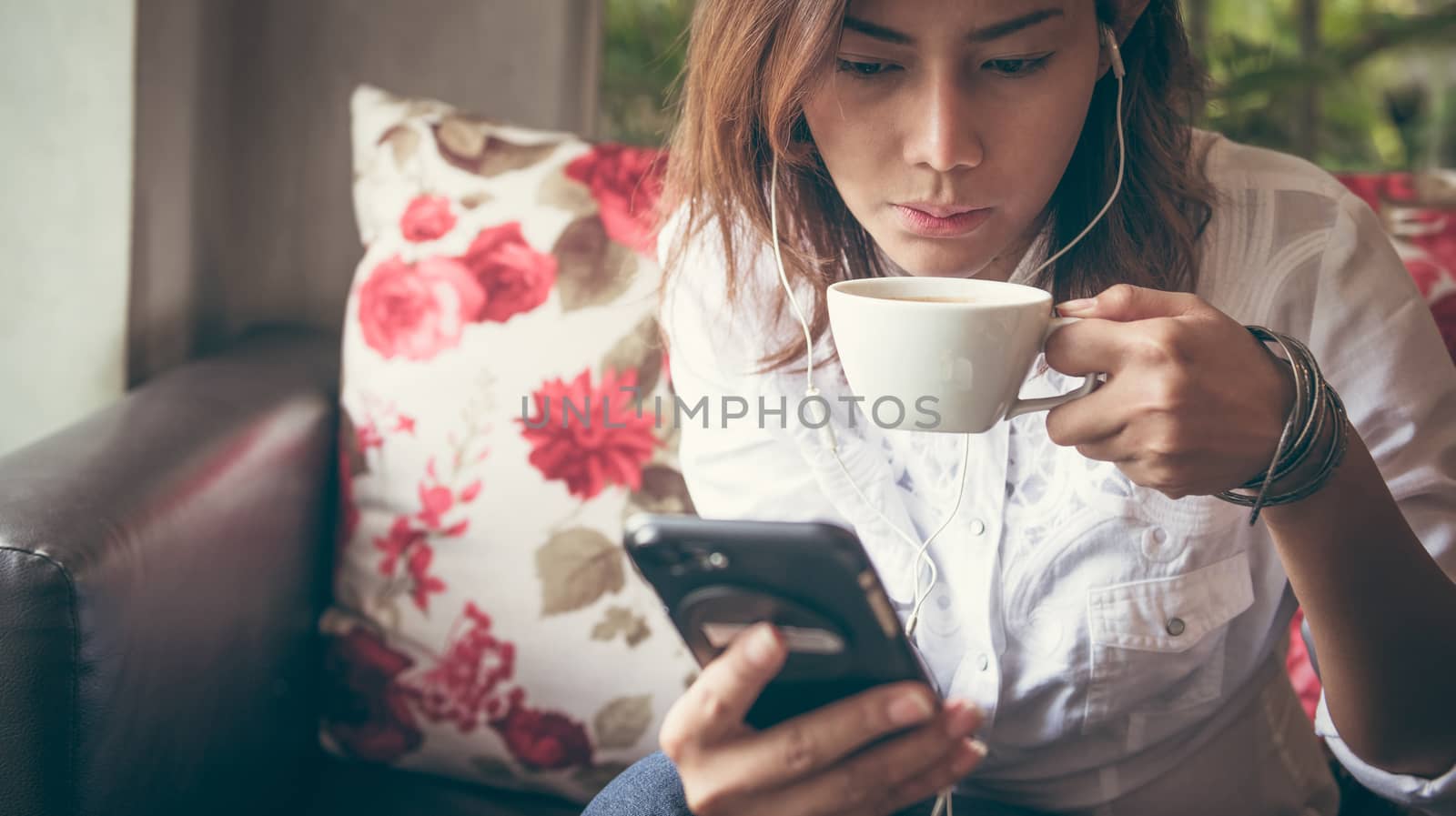 Woman drinking coffee in a cafe Vintage style photo,Focus on face