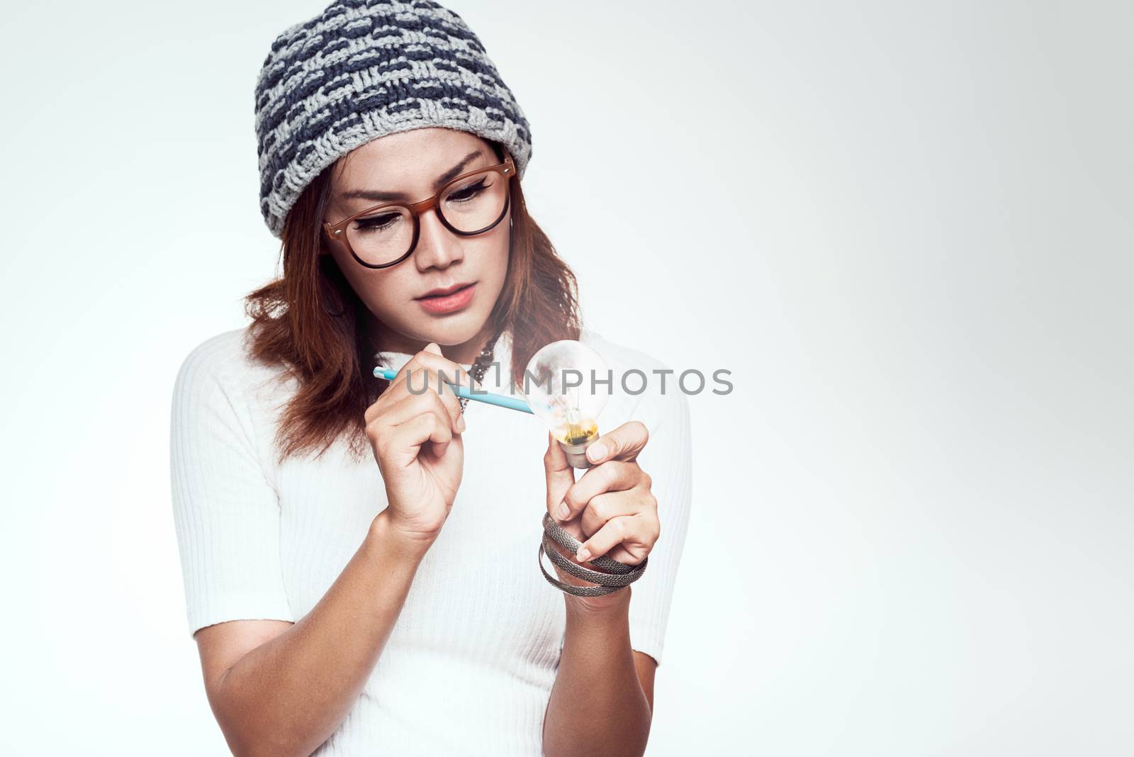 Asian woman with a light bulb idea emotionally. by PhairinThee