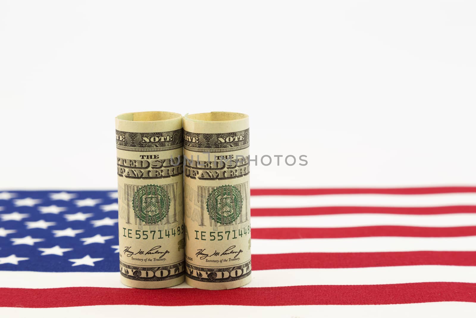 Still life of pair of dollars on American flag.  Horizontal photo with copy space.  