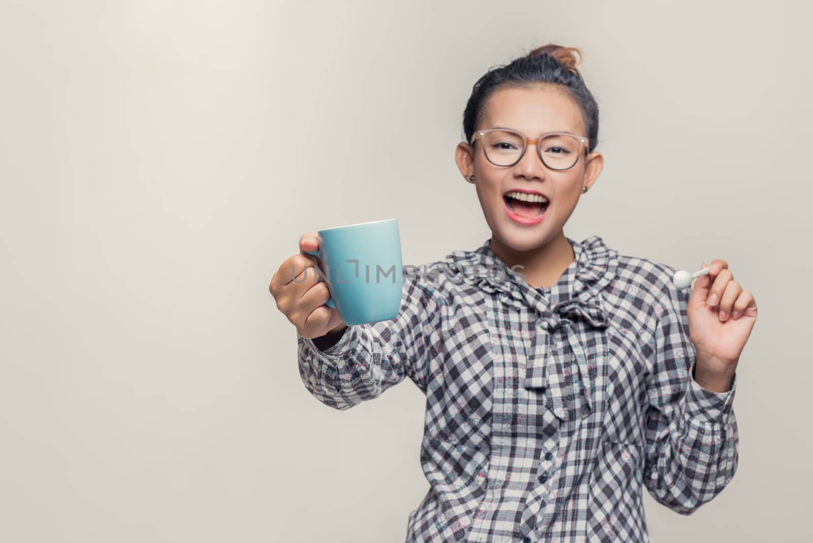 Asian woman smiling with a blue cup, Happy mood by PhairinThee