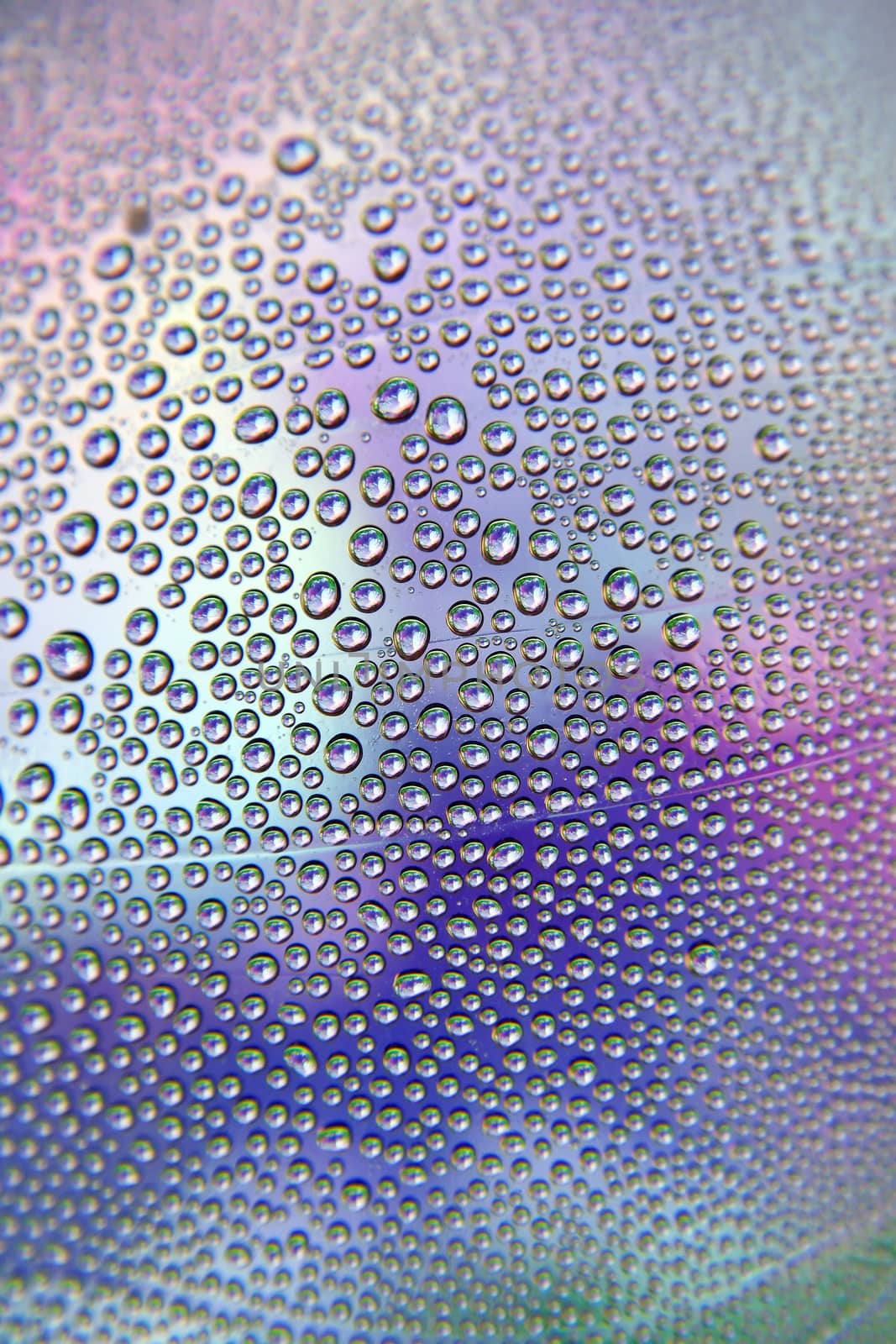 Abstract background. Drops of water on the crooked glass, shallow dof