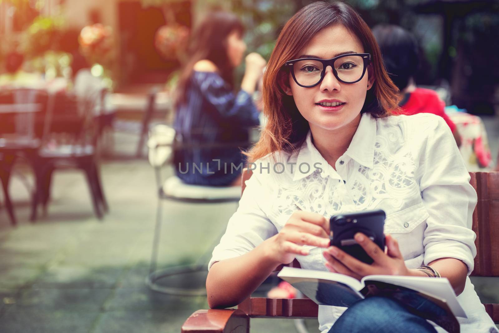 Asian woman taking notes on the phone with the intention,Focus face