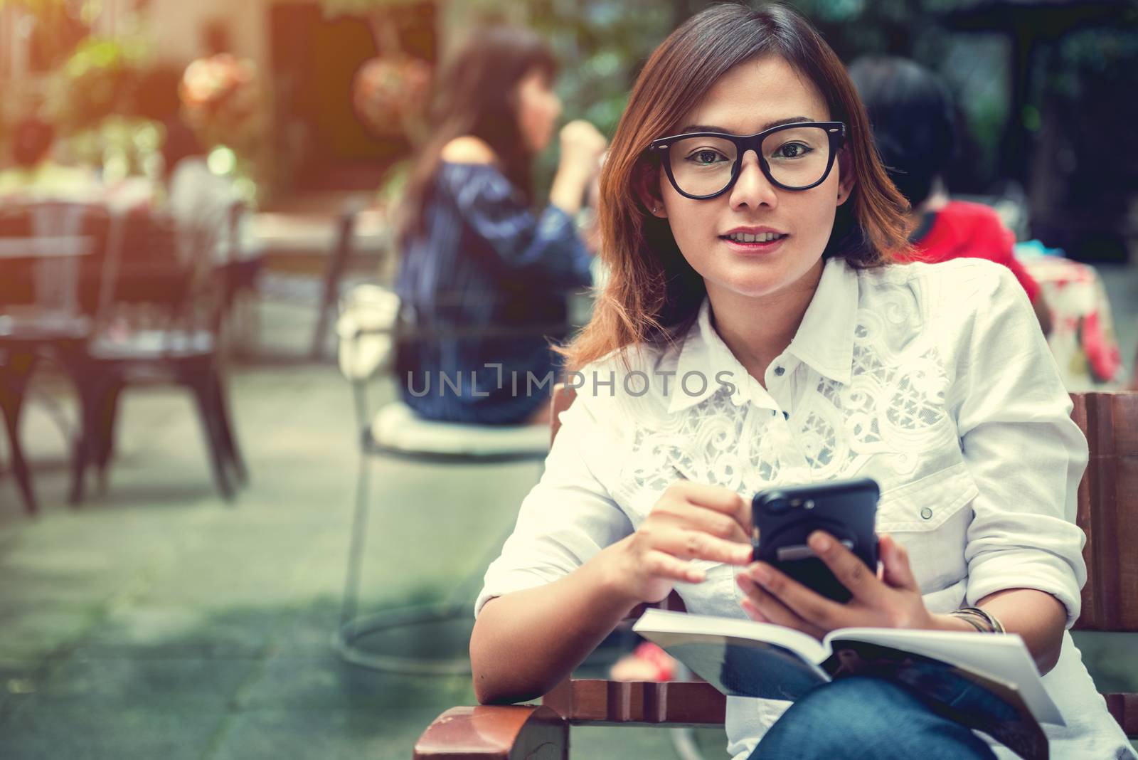 Asian woman taking notes on the phone with the intention,Focus on face