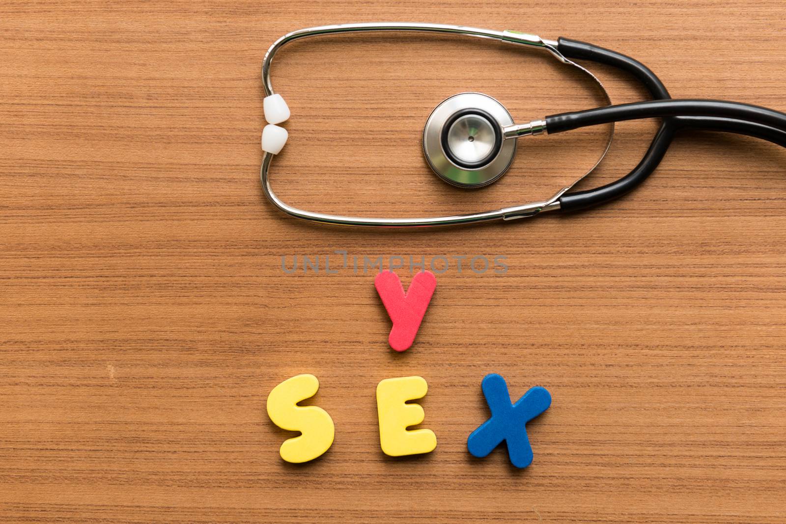 y sex colorful word with stethoscope on wooden background