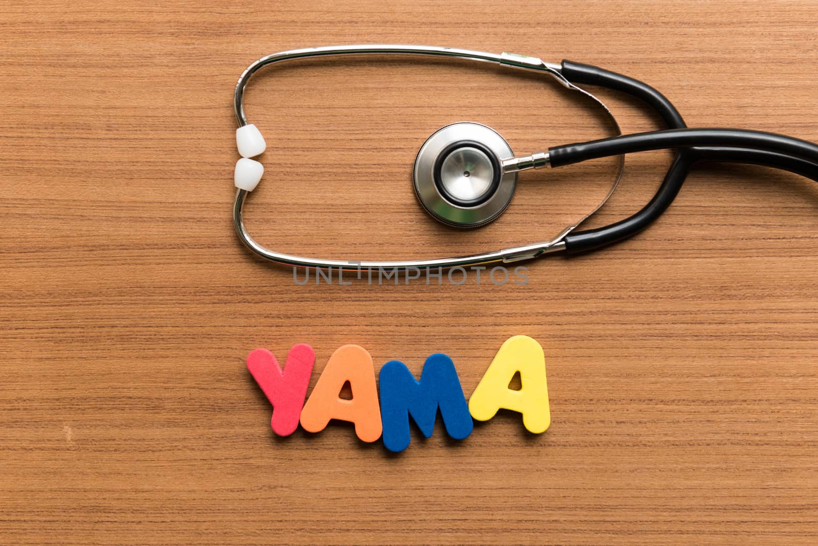 yama colorful word with stethoscope on wooden background