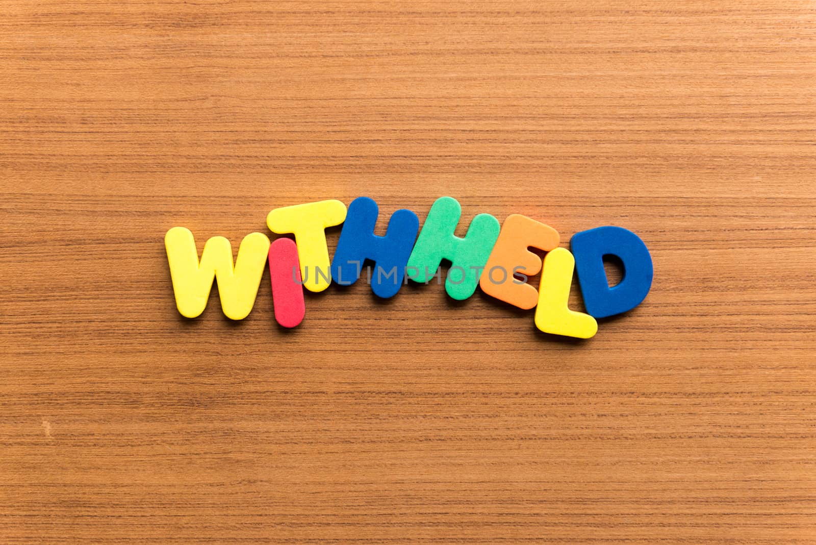 withheld colorful word on the wooden background