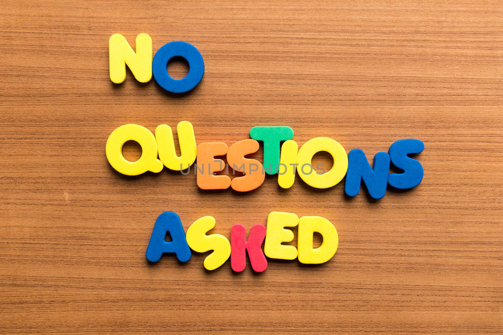no questions asked colorful word on the wooden background