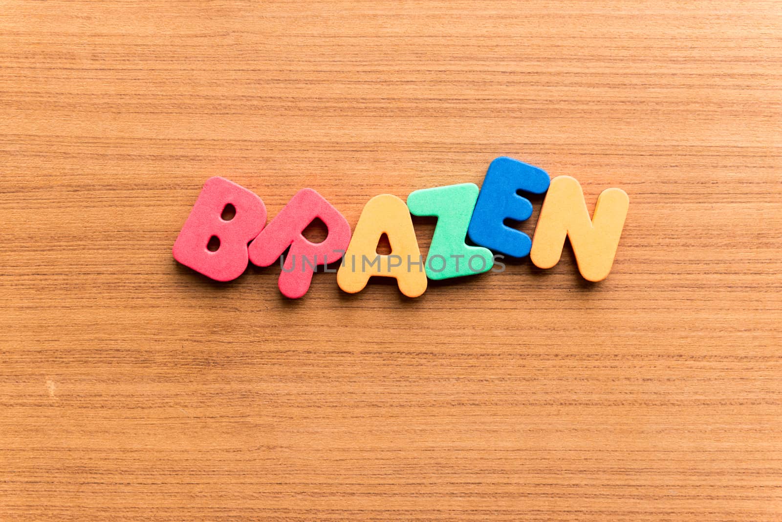 brazen colorful word on the wooden background