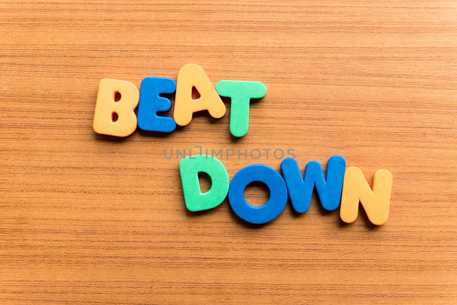 beat down colorful word on the wooden background