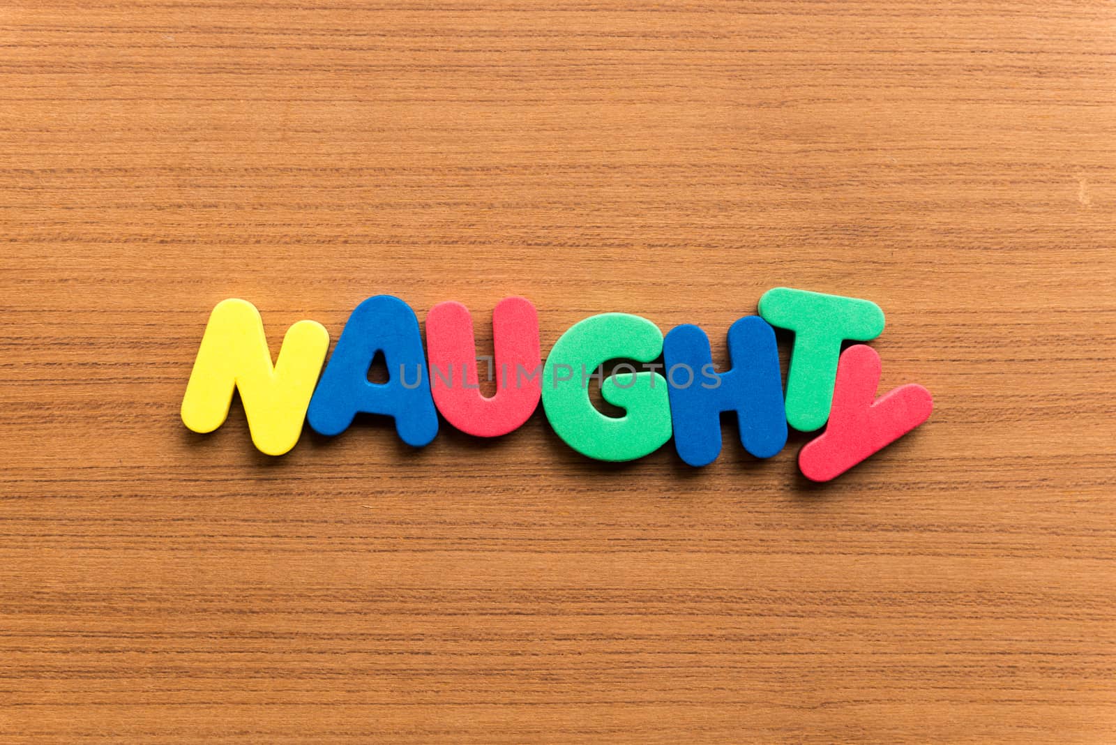 naughty colorful word on the wooden background