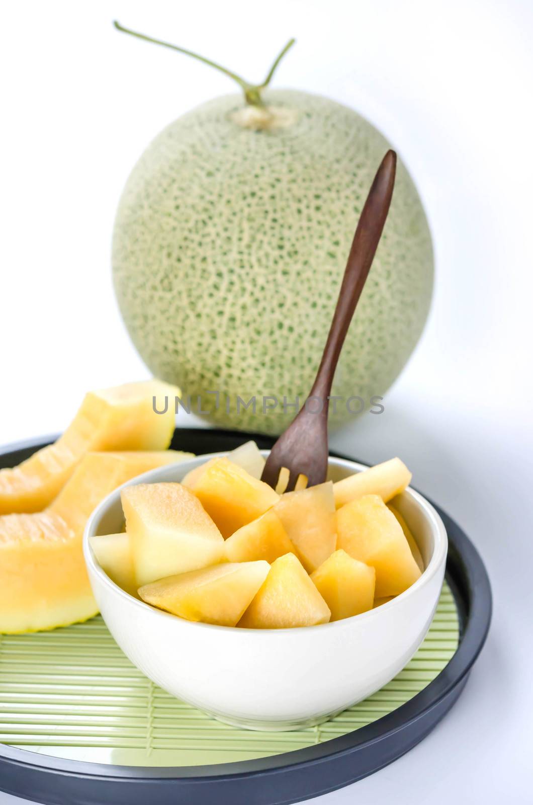 freshly cut cantaloupe melon on white background