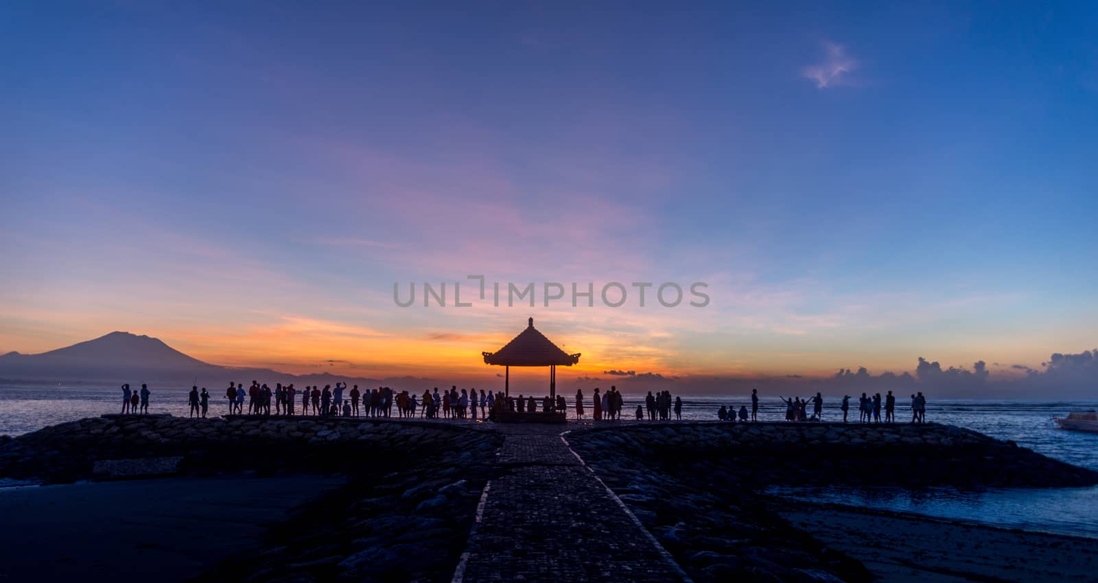 People relaxing watching a sunrise in Sanur Bali