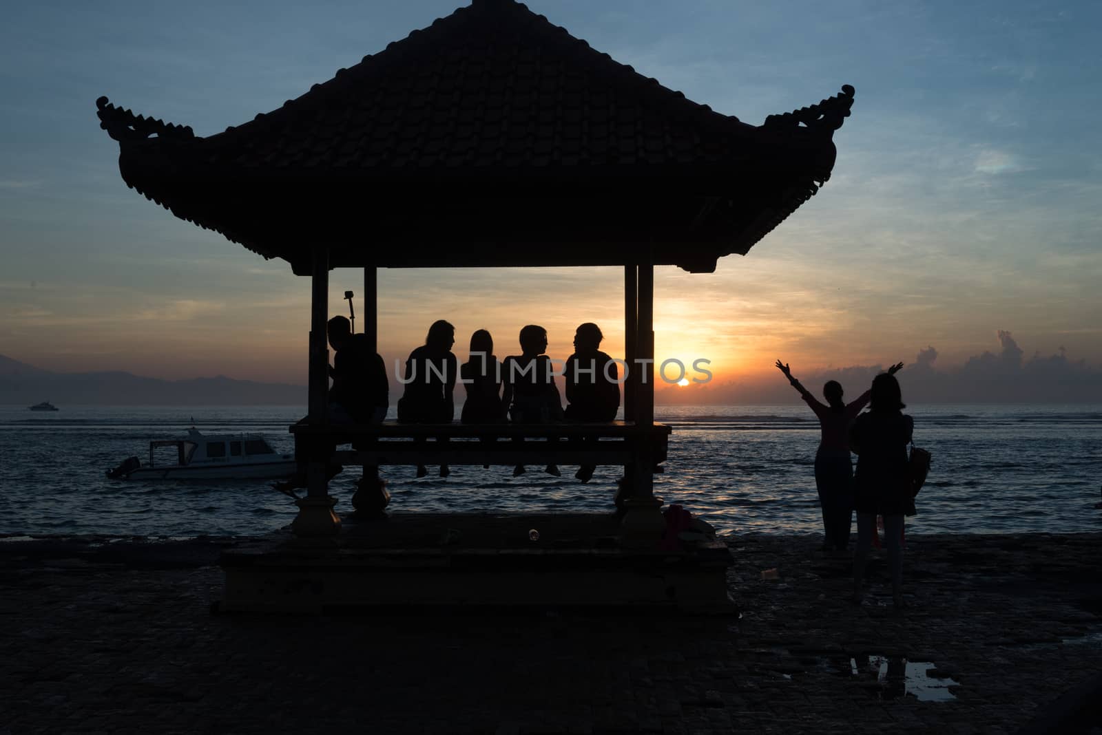 People relaxing watching a sunrise in Sanur Bali