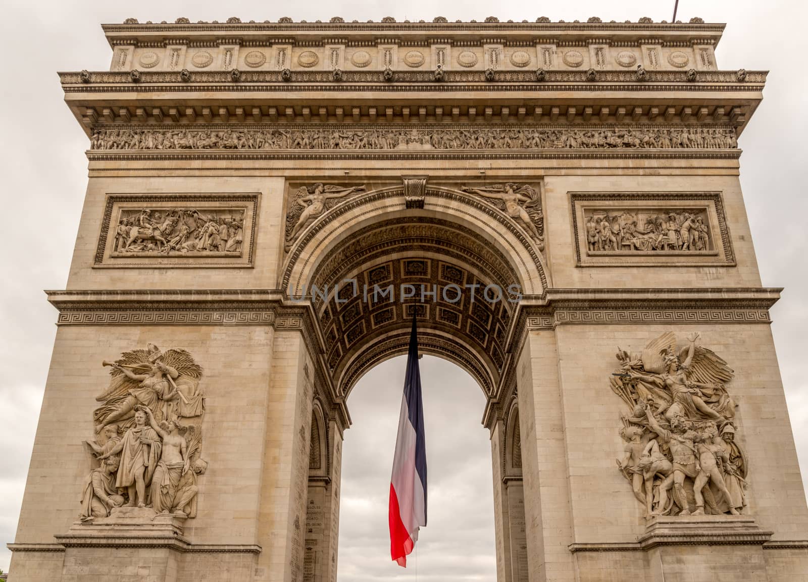 Arc de Triomphe with french flag hanging limp below
