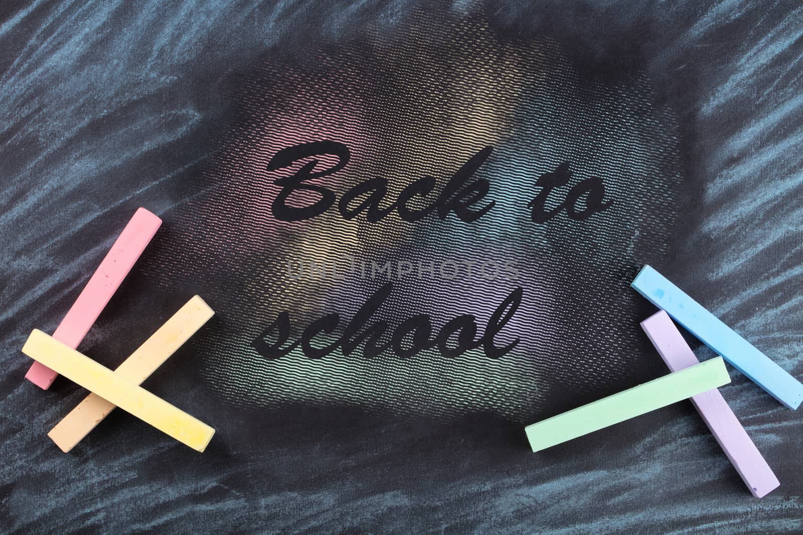 colorful crayons are painted on a black background