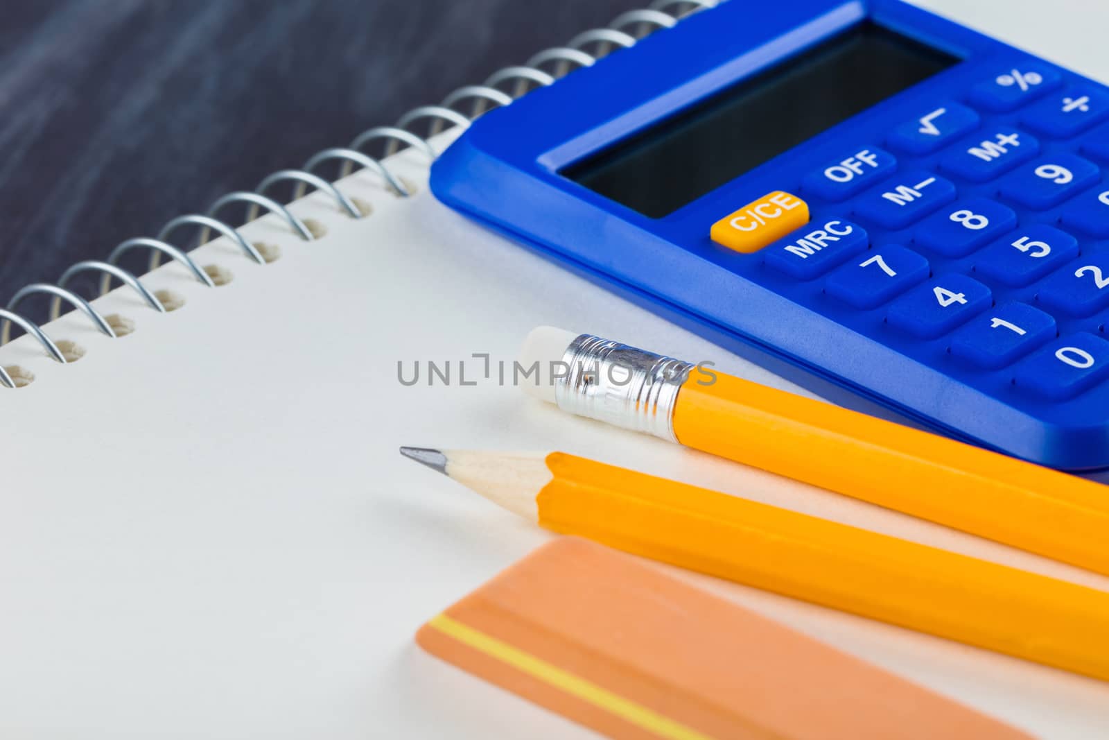 calculator and Office supplies close-up on a black background