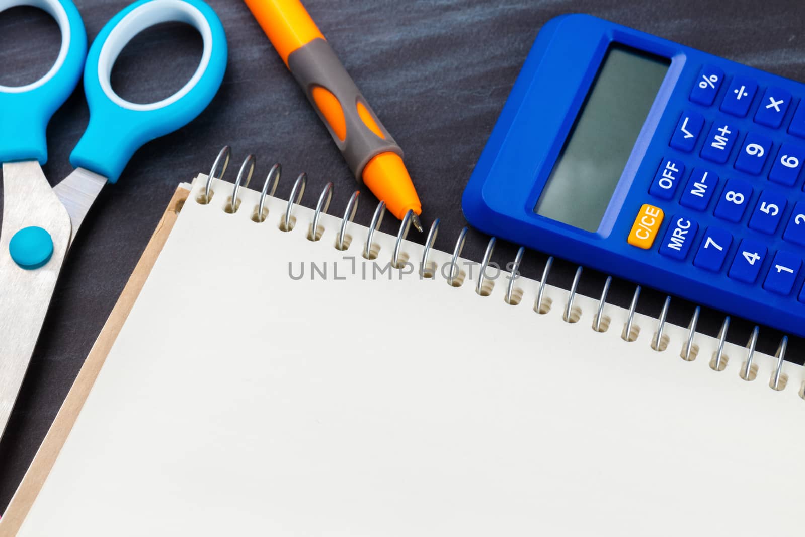 calculator and stationery close-up on a black background