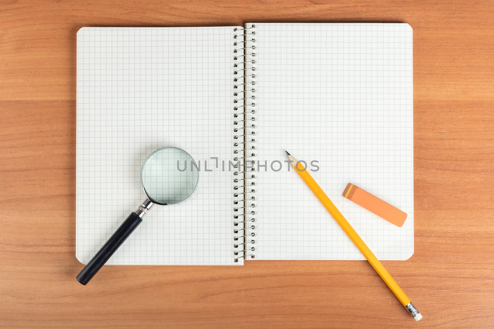 open notebook with stationery on wooden background