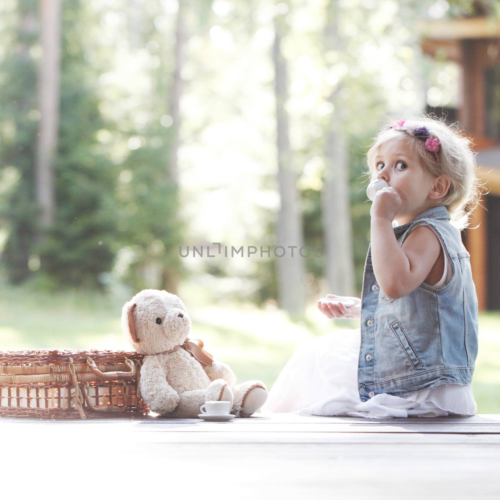 Girl playing with teddy bear by ALotOfPeople