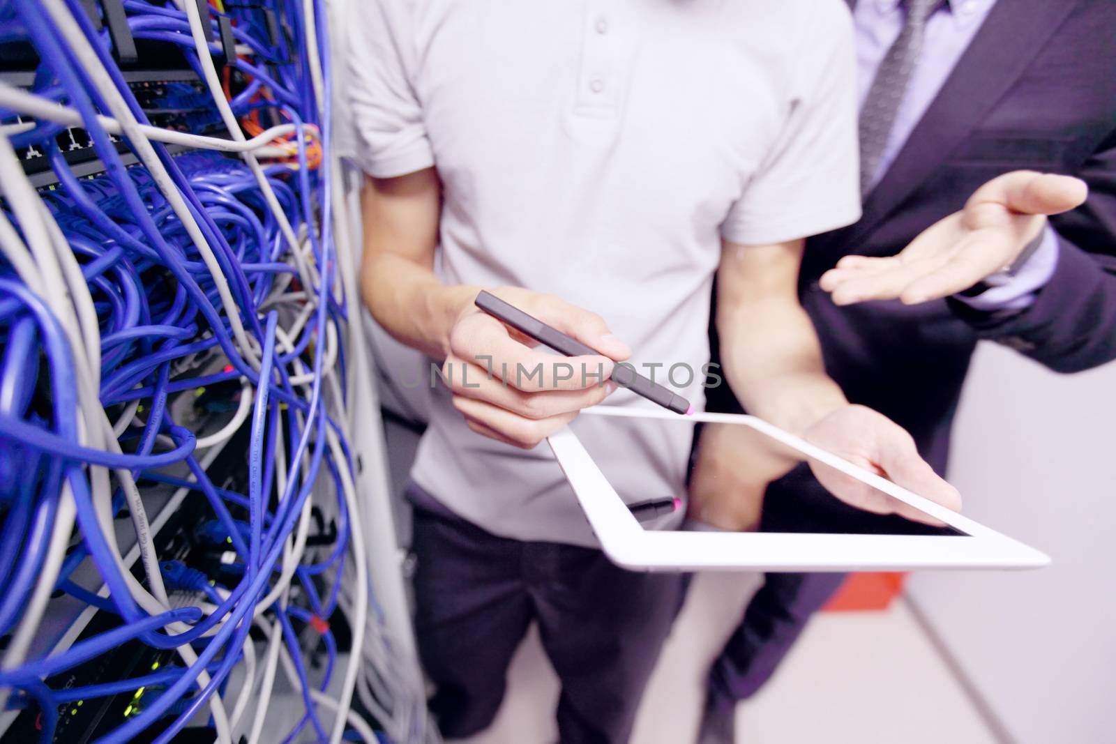 Men in network server room by ALotOfPeople