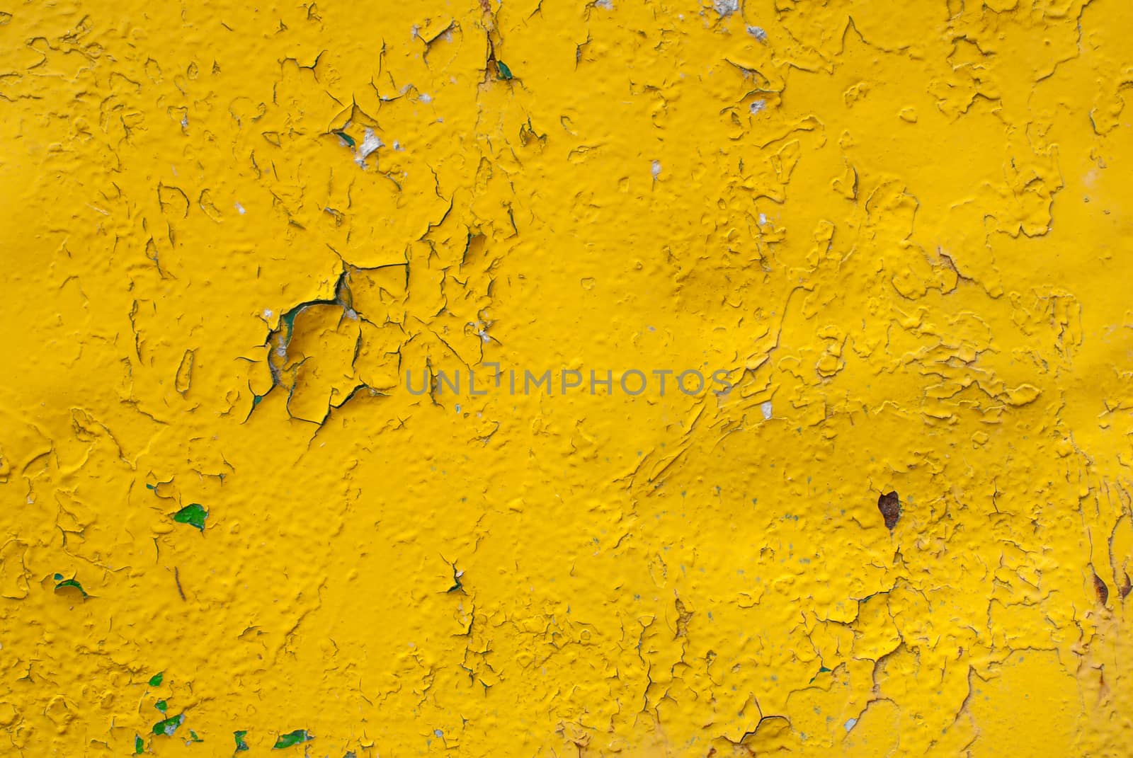 fragment of an iron surface is covered with yellow color paint, which has long been under the influence of different climatic conditions