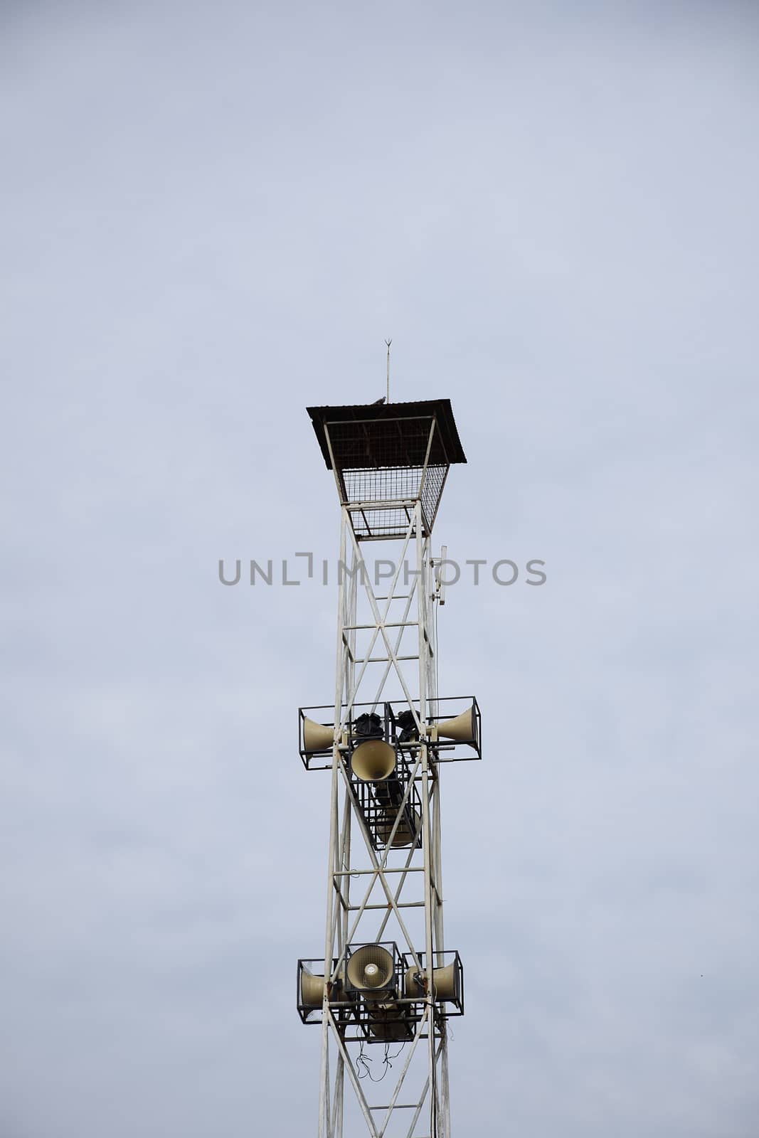 Loudspeakers broadcast tower on sky background. by sky_sirasitwattana