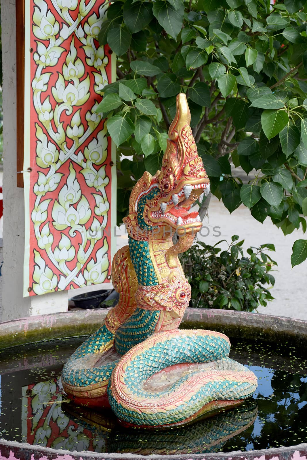 The art of concrete Naga on water. Serpent stucco in thailand.