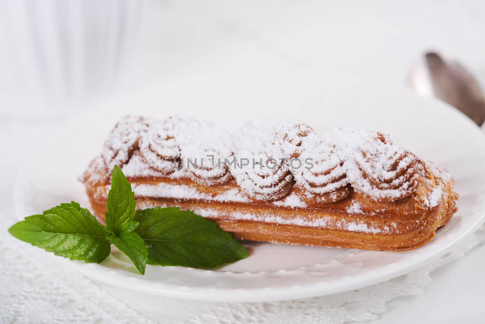 Eclairs on plate on a table  by kzen