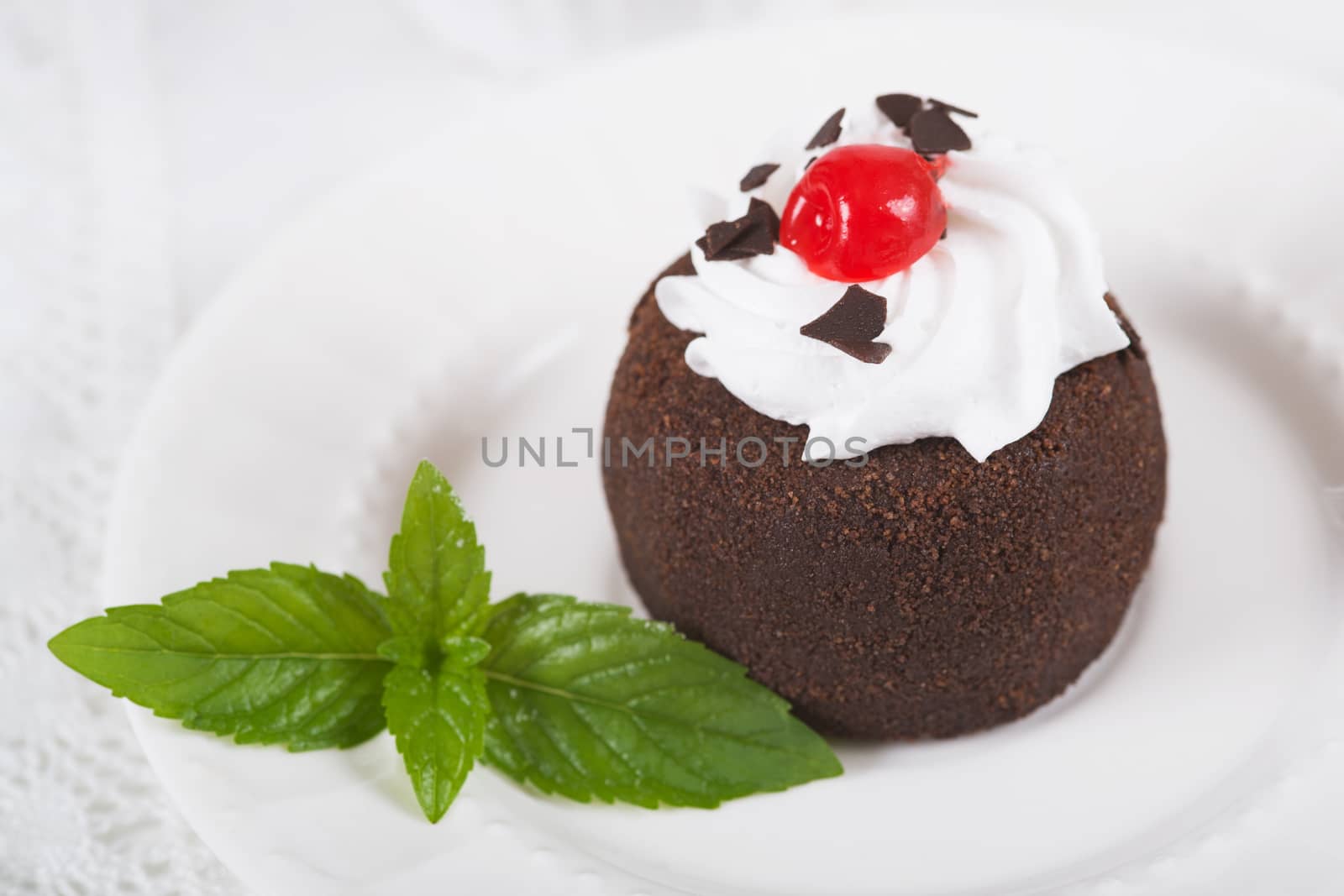 Chocolate sweet cake "Potato" on a plate on table, selective focus