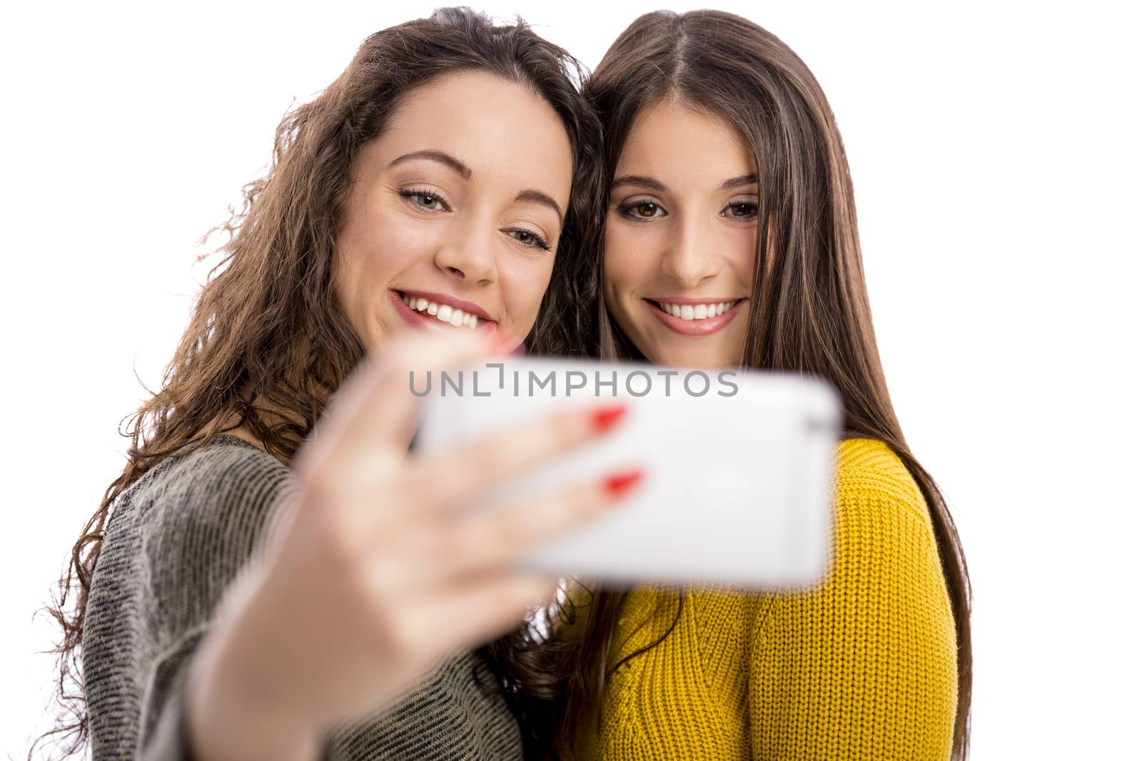 Teen girls with smartphone taking selfie