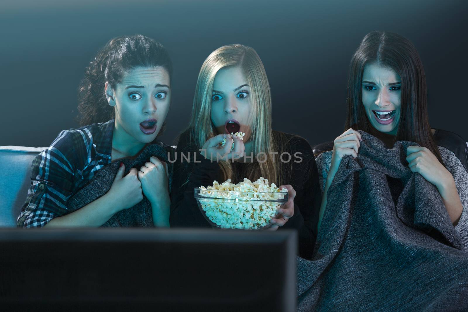 Scared teenage watching movies  by Iko