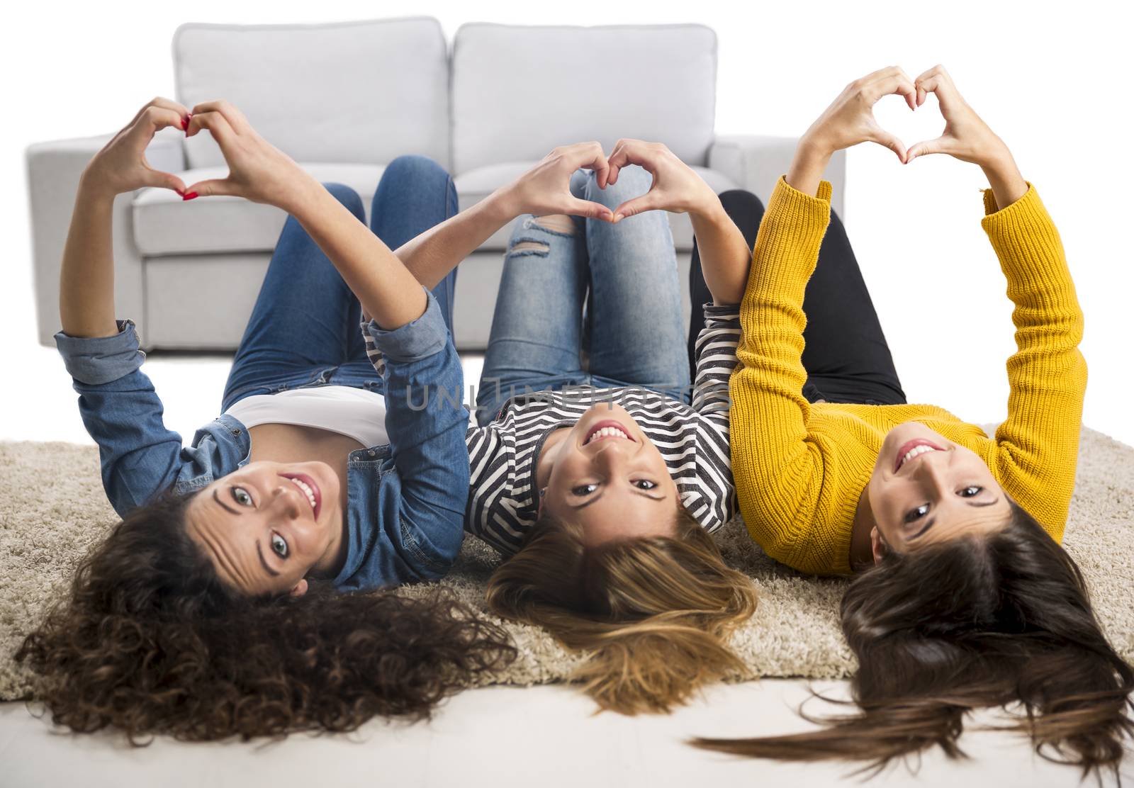 Happy teen girls at home lying in the floor