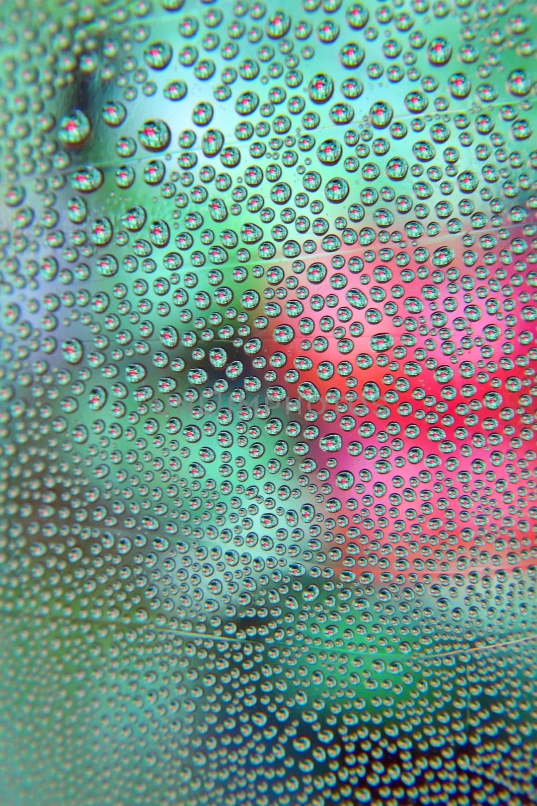 Abstract background. Drops of water on the crooked glass, shallow dof