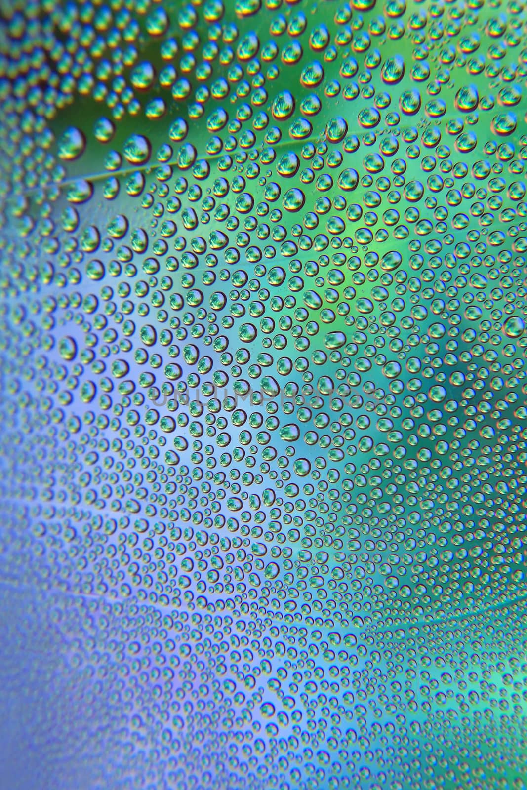 Abstract background. Drops of water on the crooked glass, shallow dof