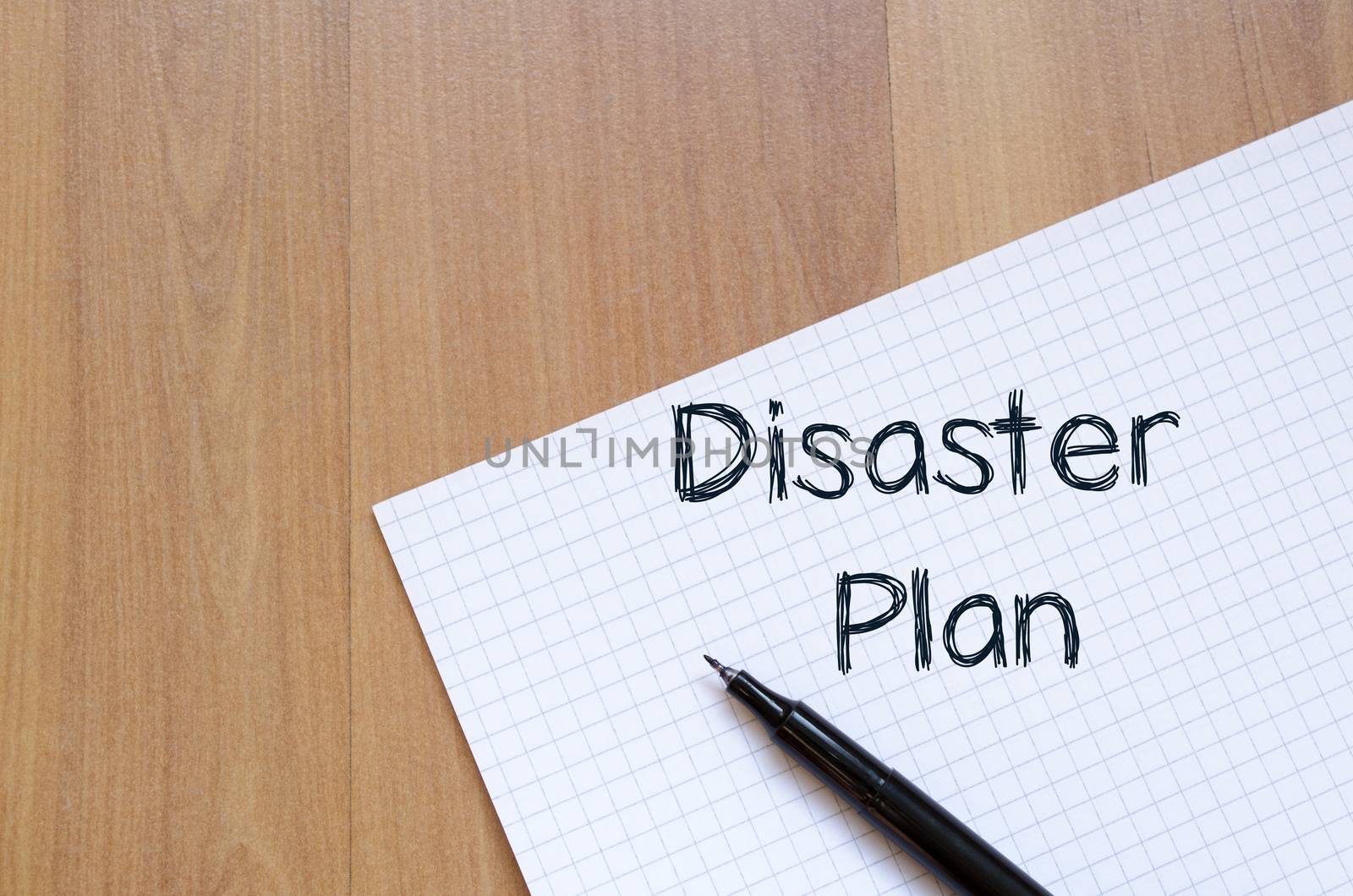 Disaster plan text concept write on notebook with pen
