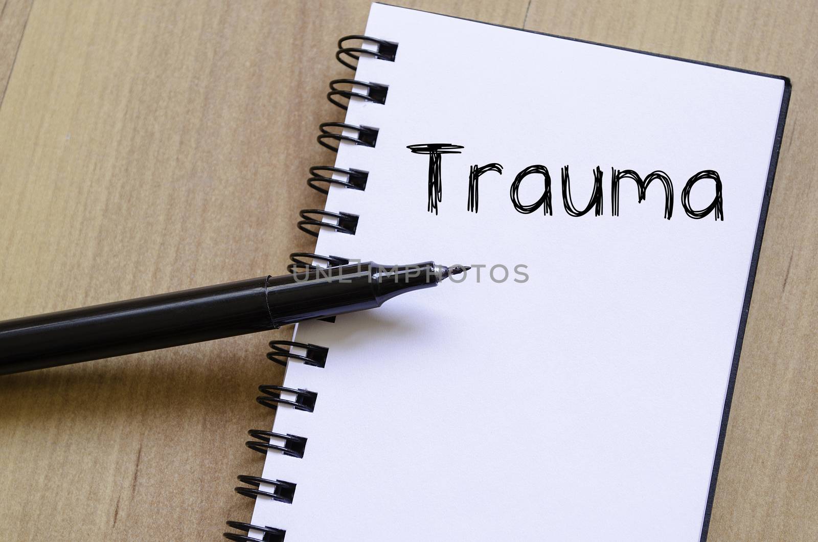 Trauma text concept write on notebook with pen