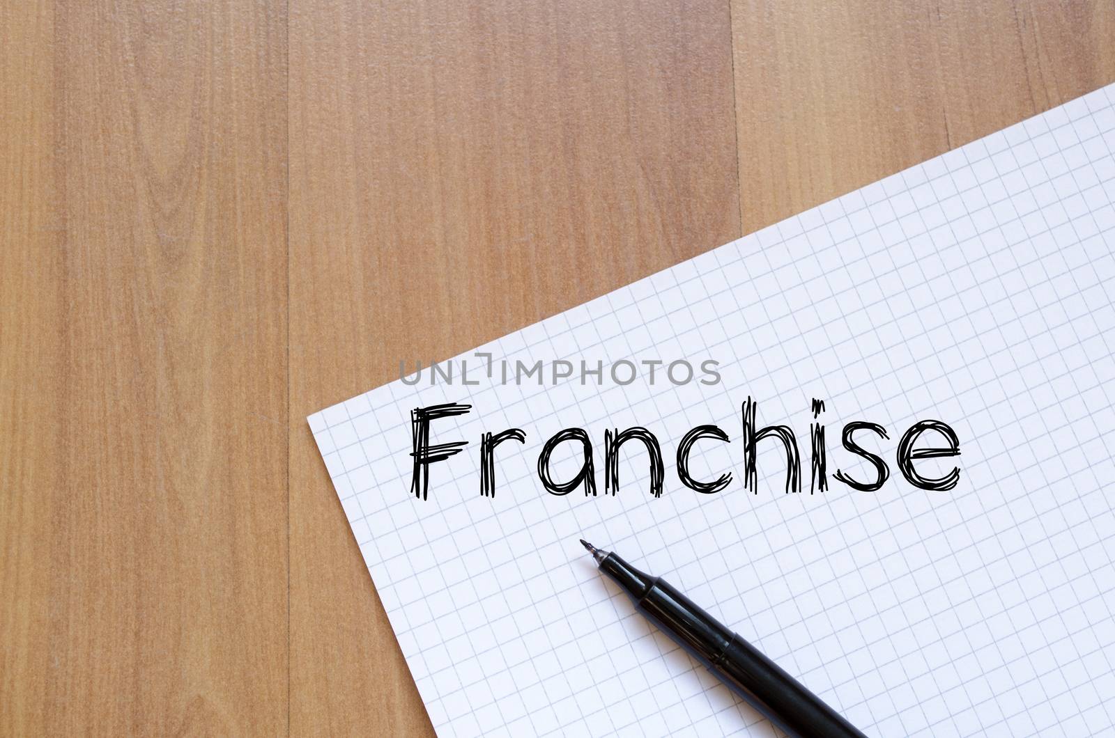 Franchise text concept write on notebook with pen