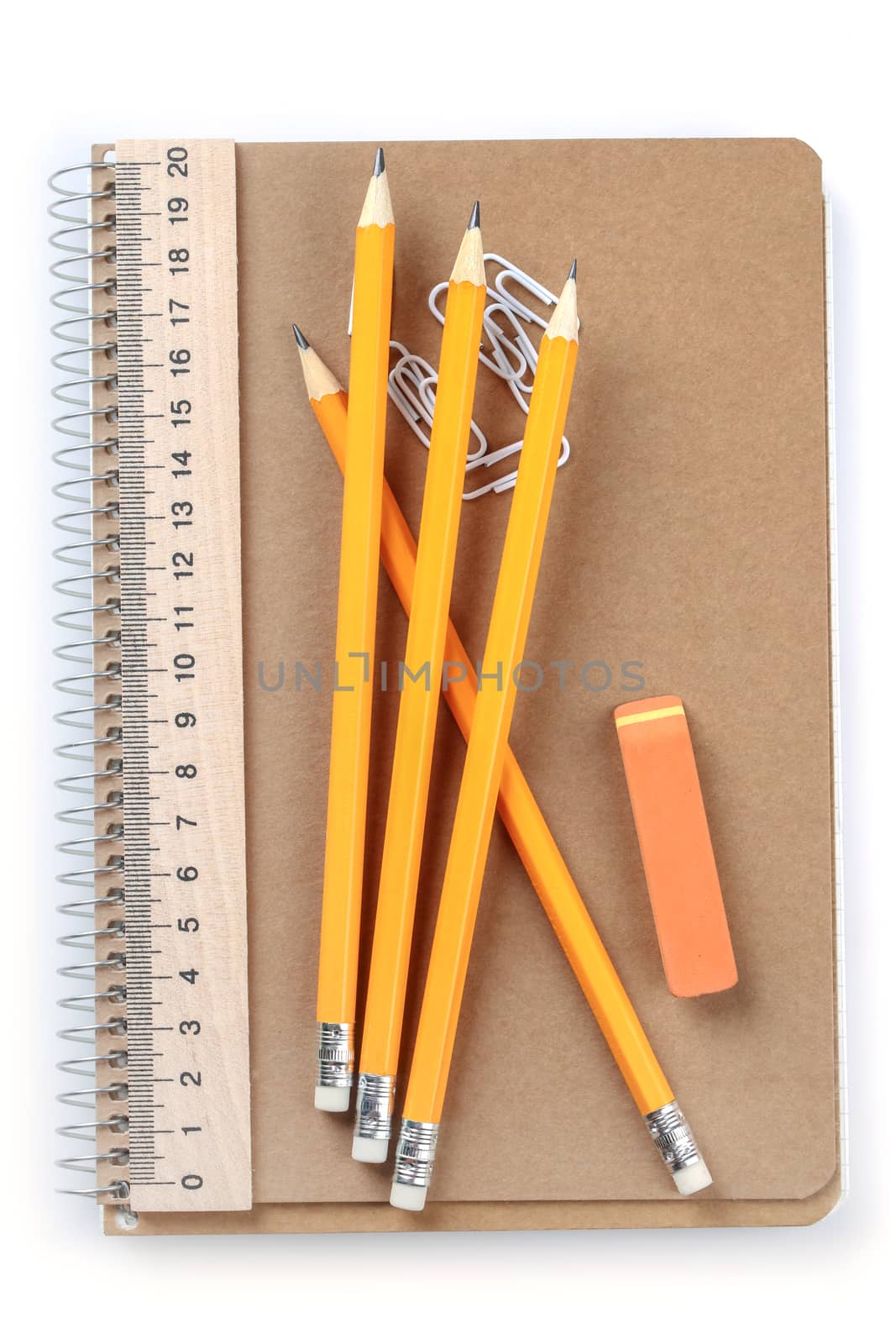 notebook, eraser, ruler, pencil and paperclips on white background