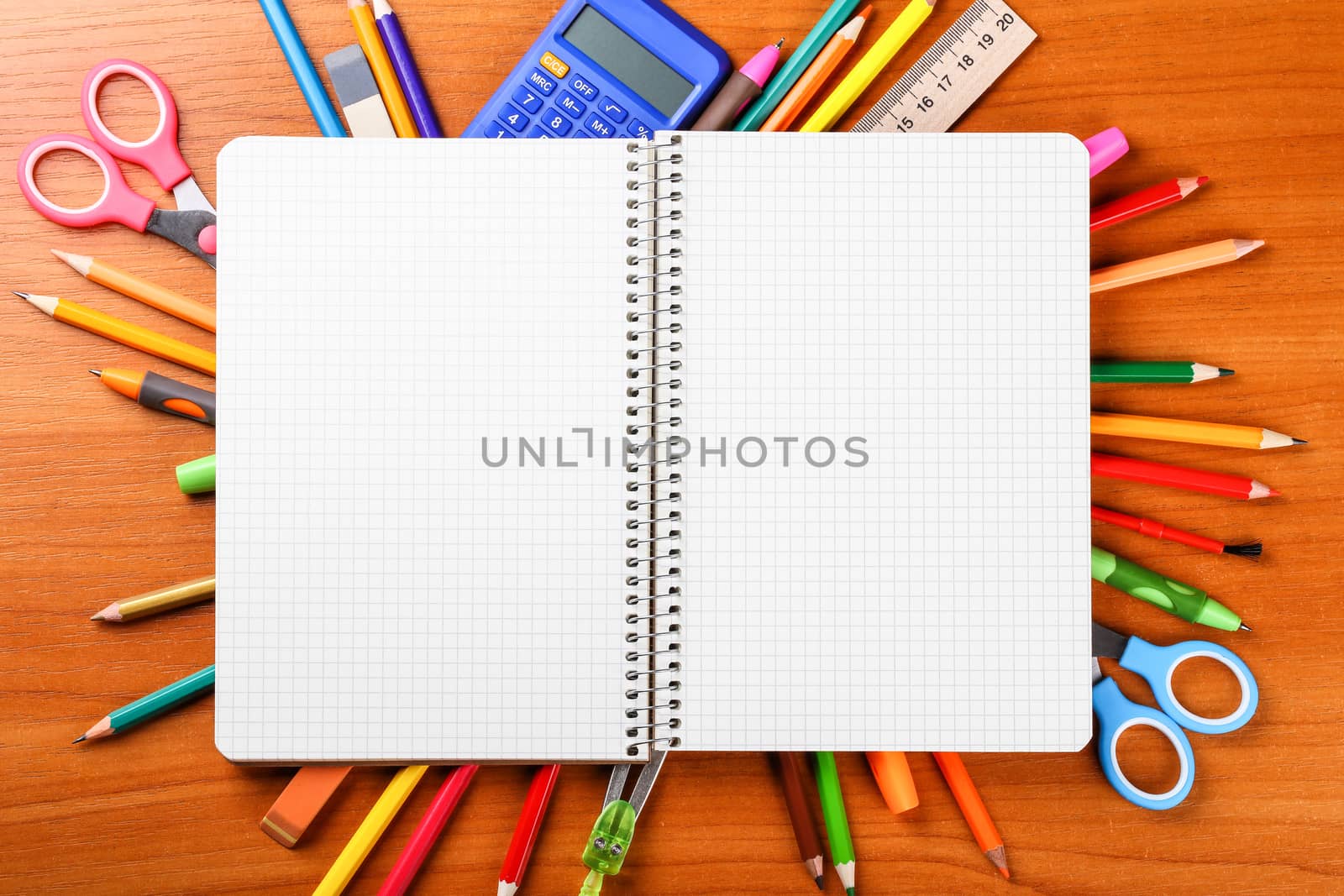 open notebook with stationery on wooden background