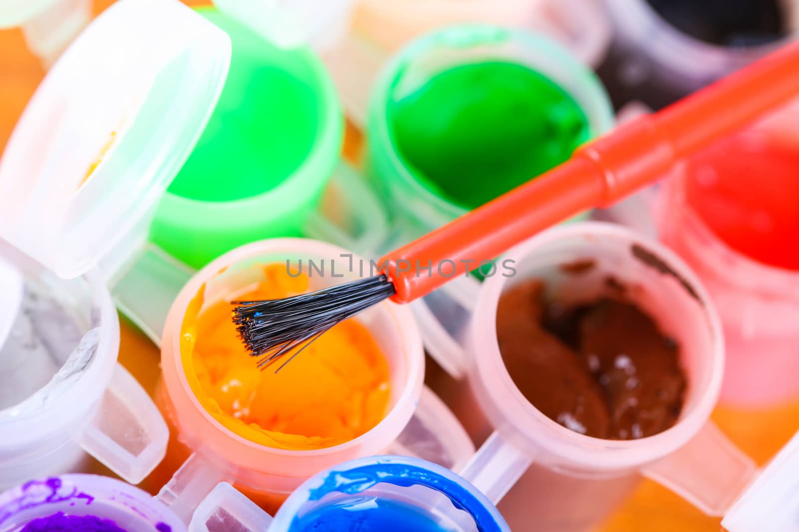 set of colorful paints close-up on wooden background
