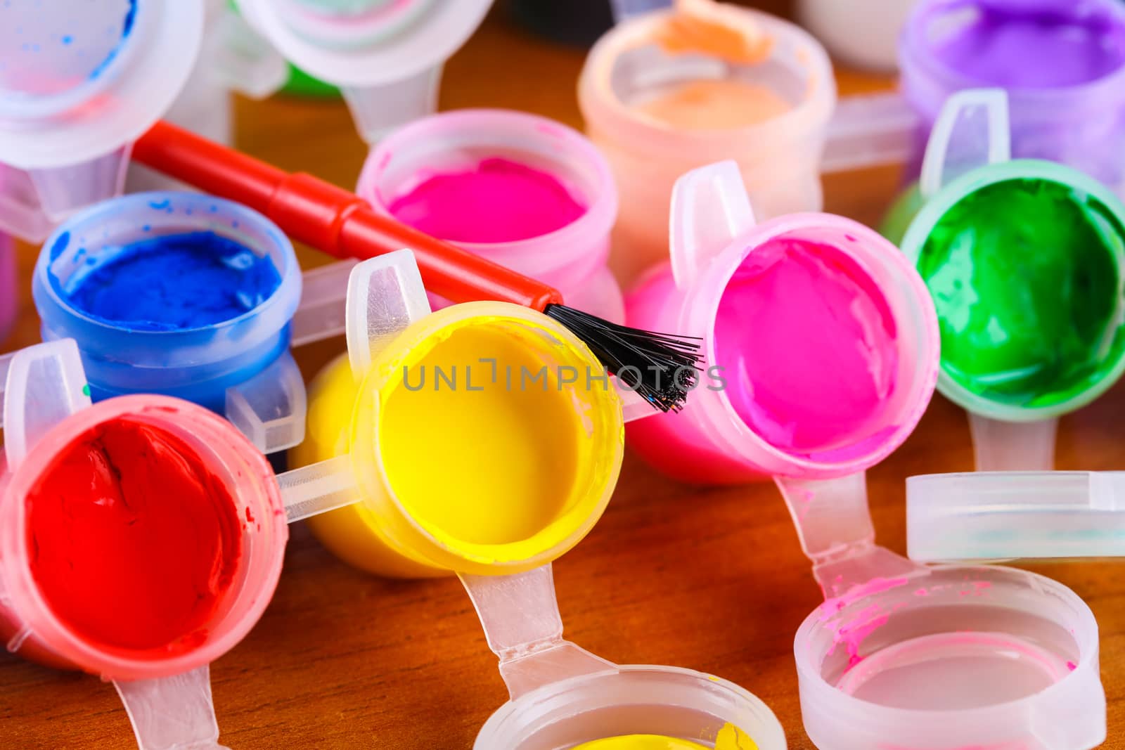 set of colorful paints close-up on wooden background