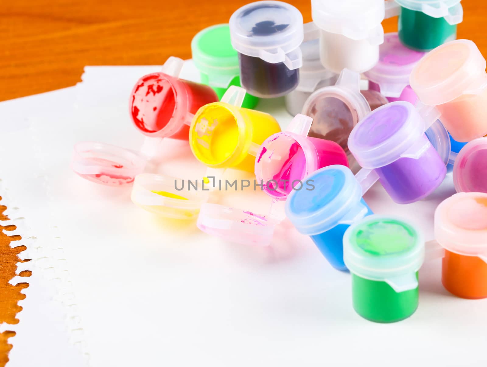 set of colorful paints close-up on wooden background