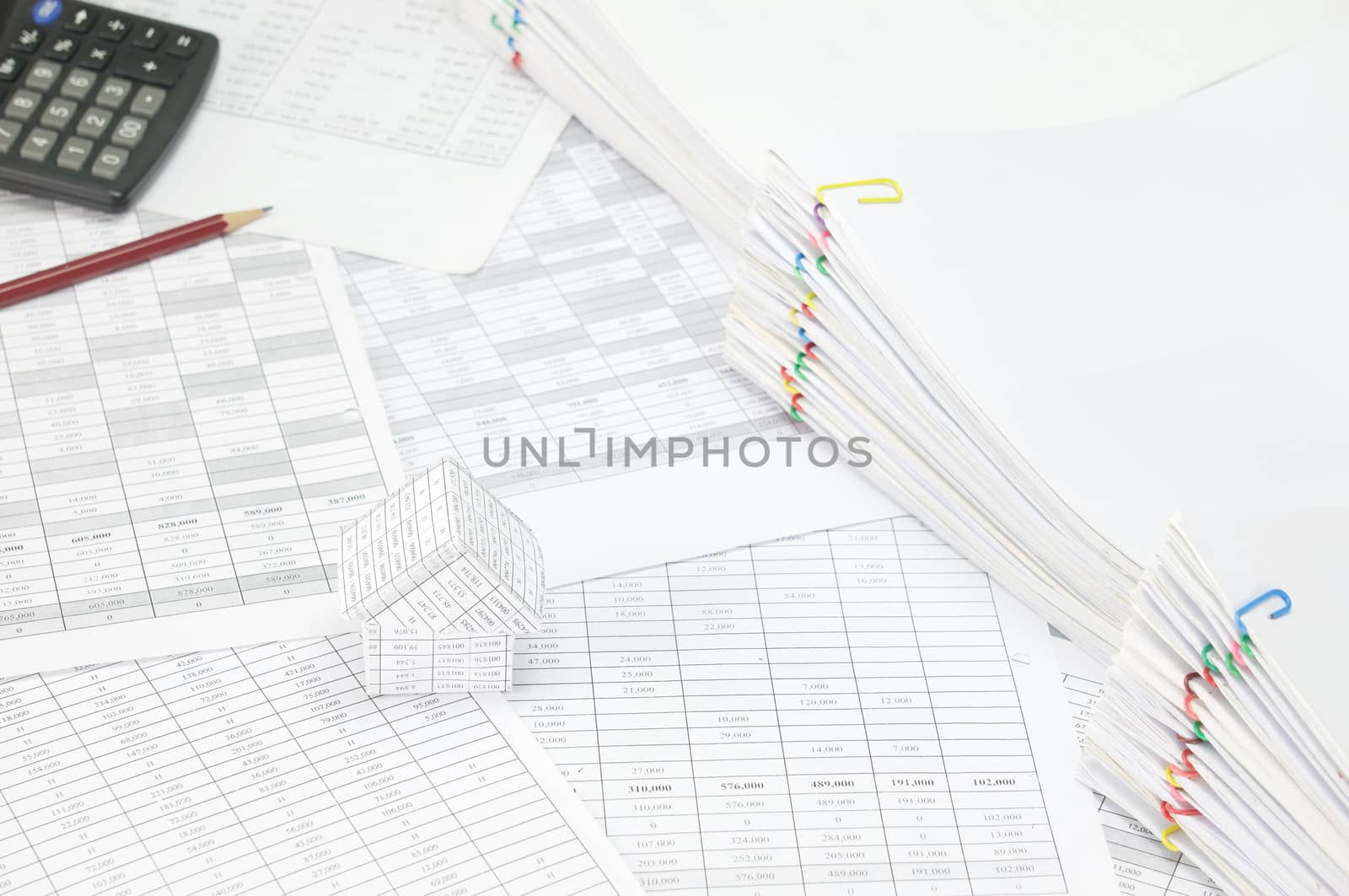 House have blur pencil with calculator and overload of paperwork by eaglesky