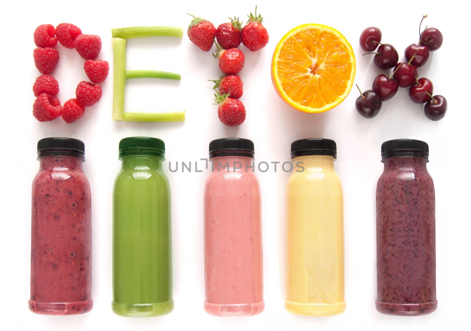 Detox word made with fruits from assorted fruit smoothies over a white background 