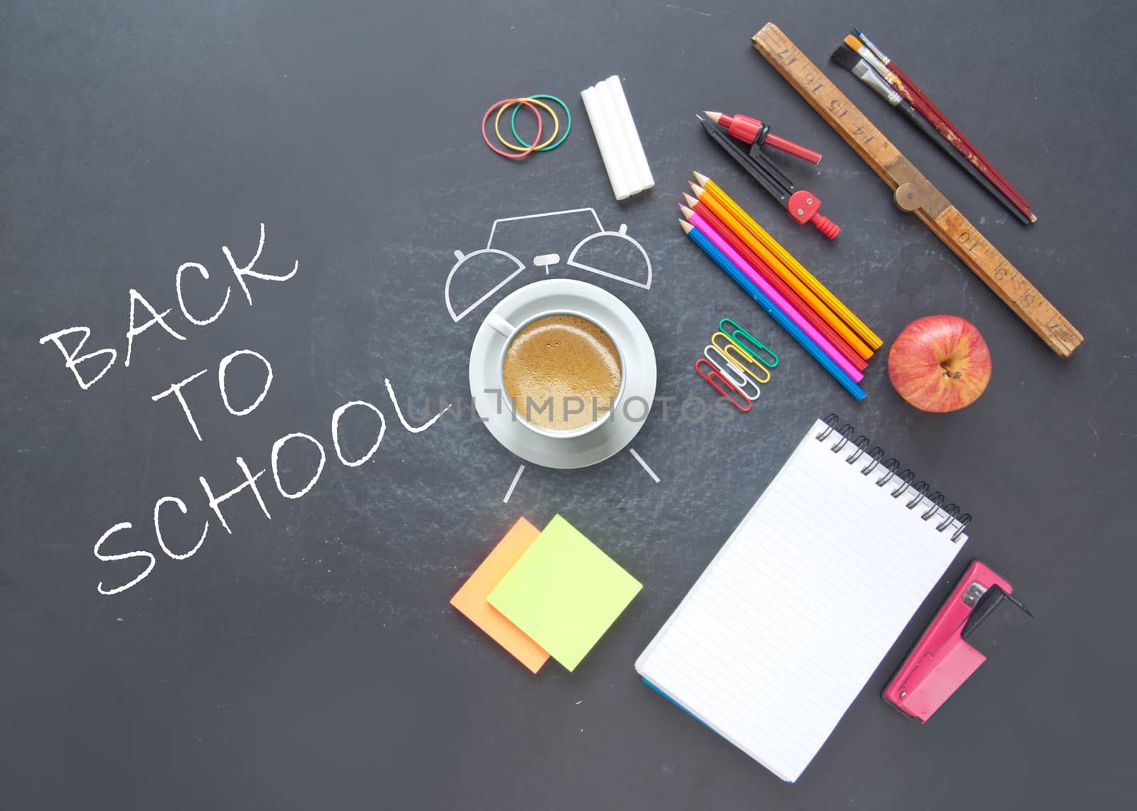 Back to school background with alarm clock drawn around a coffee cup and stationery accessories