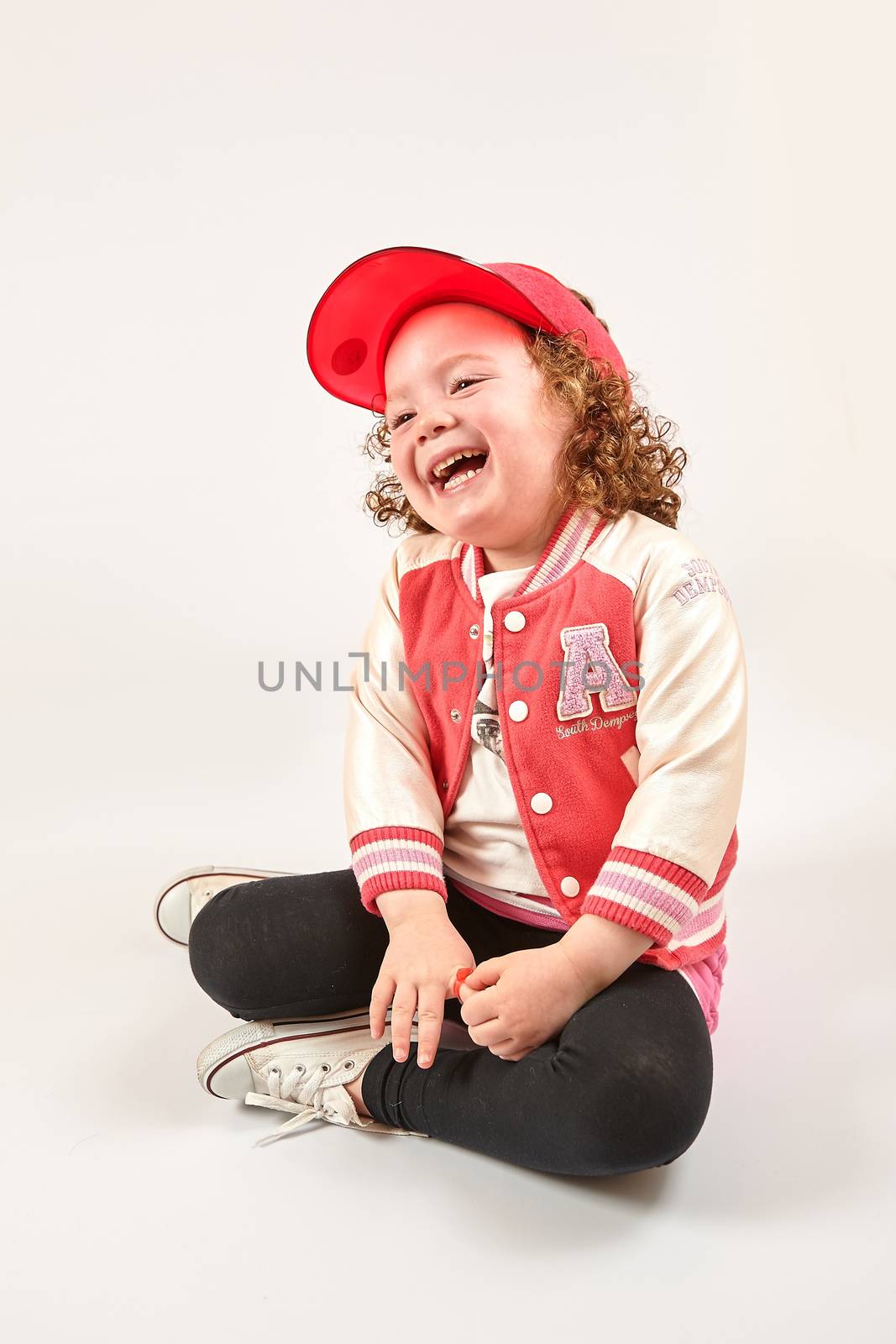 Little Girl Fashion Model With Red Cap by Multipedia