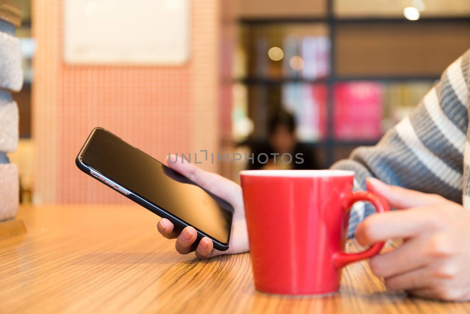 Woman with mobile phone at coffee shop by leungchopan