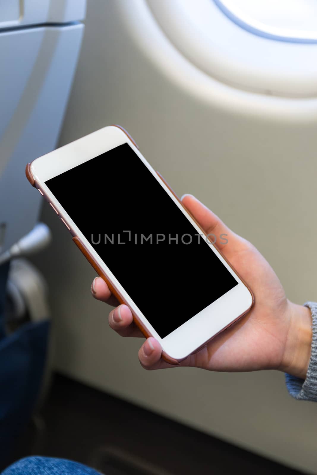 Woman use of mobile phone in plane